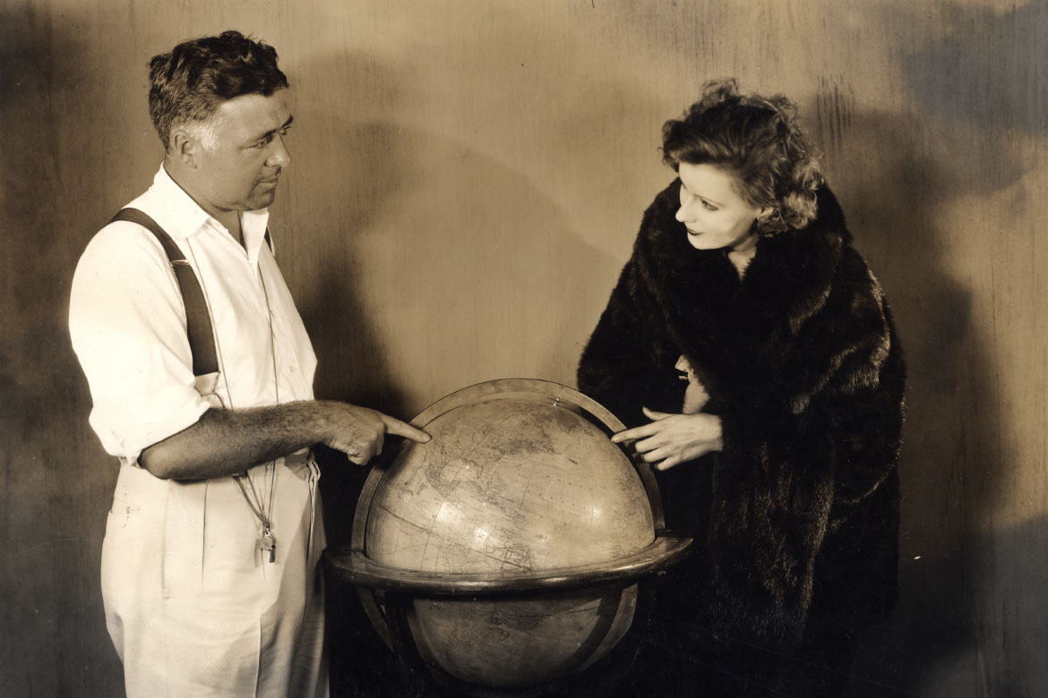 Clarence Brown and Greta Garbo with a globe
