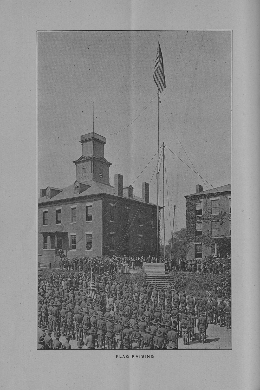 Officers in training stand at attention during the raising of the flag in 1918.