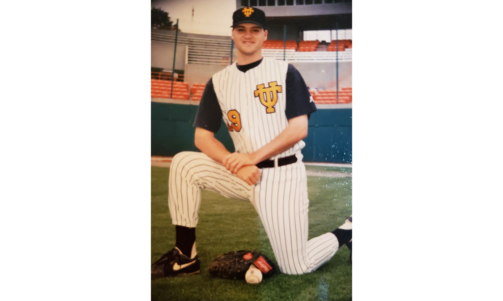 Exum wearing a striped Vol Baseball uniform in the 1990s