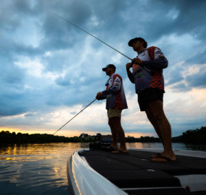 Austin Wadzinski and Conner Hicks, of the UT Bass Fishing team, fish off the front of a boat at sunrise on the Tennessee River on June 29, 2022. Photo by Steven Bridges/University of Tennessee.