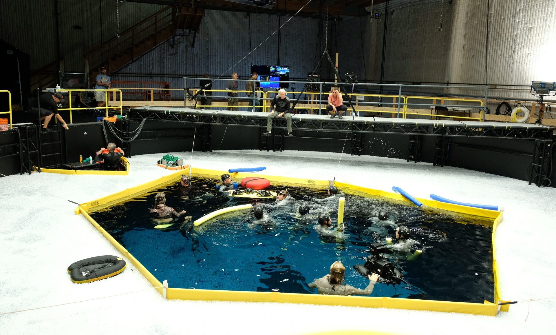 A movie set with a pool of water with people in it