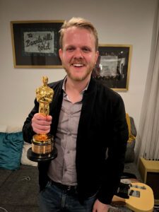 Ben Murphy holding an Oscar statue