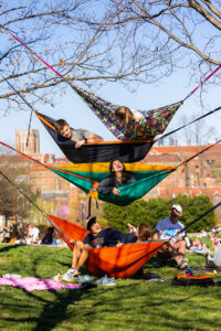 Students in four hammocks placed above one another. 
