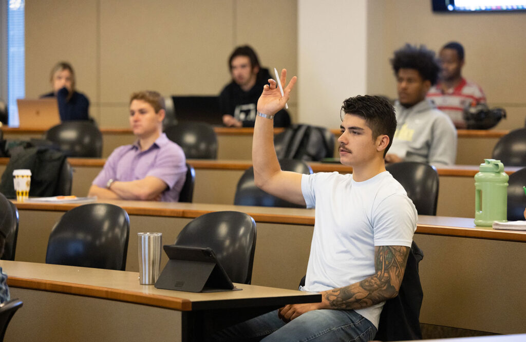 Vickery raising his hand in class.