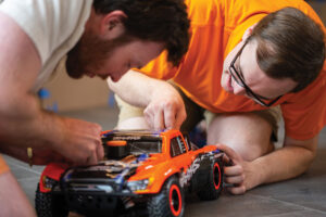 Two students work on a RC car