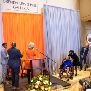 Brenda Peel, her family, Chancellor Plowman, and others witness the unveiling of the Brenda Peel Galleria.