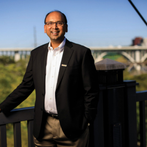 Portrait of Dr. Penumadu standing on the bridge that connects the Hill to the Tickle Engineering building.