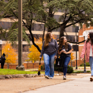 Abby Thongbai talks with friends while walking across campus.
