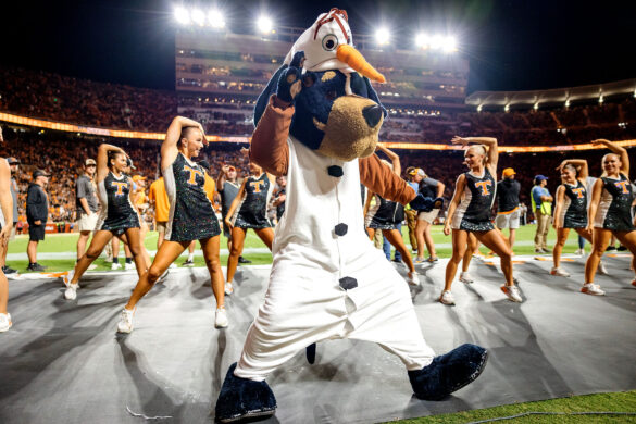 Mascot Smokey, dressed as Olaf the Snowman from Frozen, dances on the sidelines with the cheerleaders