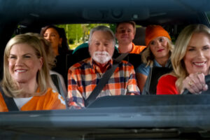 A family wearing UT orange rides together in a vehicle--it appears from the way they are dressed that they may be going to a UT football game